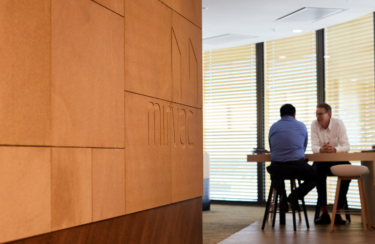 Men sitting at meeting table at EY Cnetre 200 George Street by Mirvac