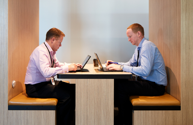 Two men sitting at meeting space at EY Centre 200 George Street Sydney