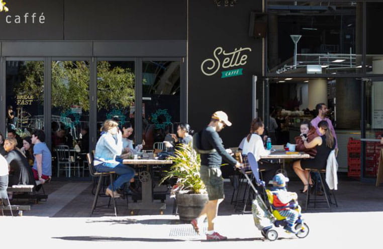 People walking in front of cafe