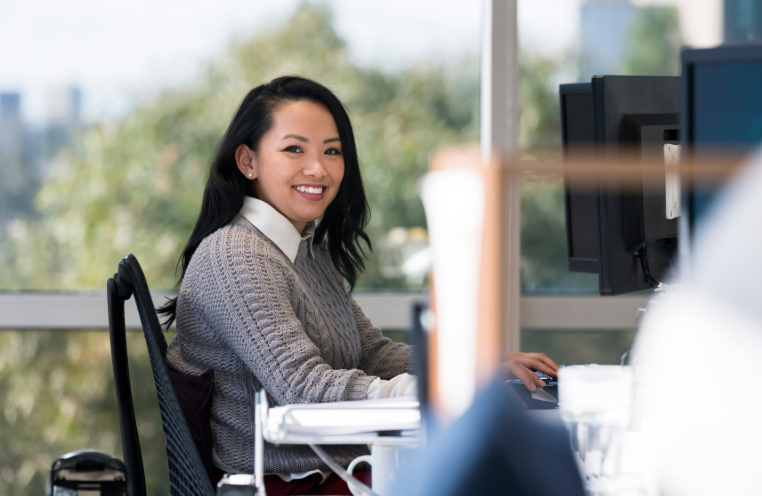 Woman smiling and sitting at desk